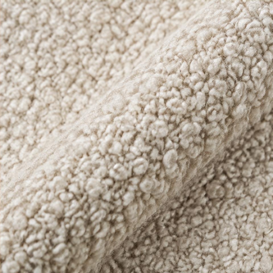 Detalhe nítido da textura de bouclé — amostra ilustrativa